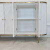 white chest of drawers, fluted front, sintered stone top, golden elements, sophisticated