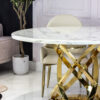 Round dining table, on a gold metal base, white top imitating marble, modern, elegant