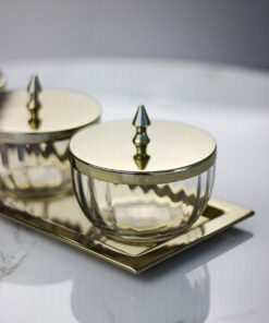 set-of-four-containers-on-a-straight-sided-gold-tray-gold-metal-lids-with-handles-glass-containers-classic-style