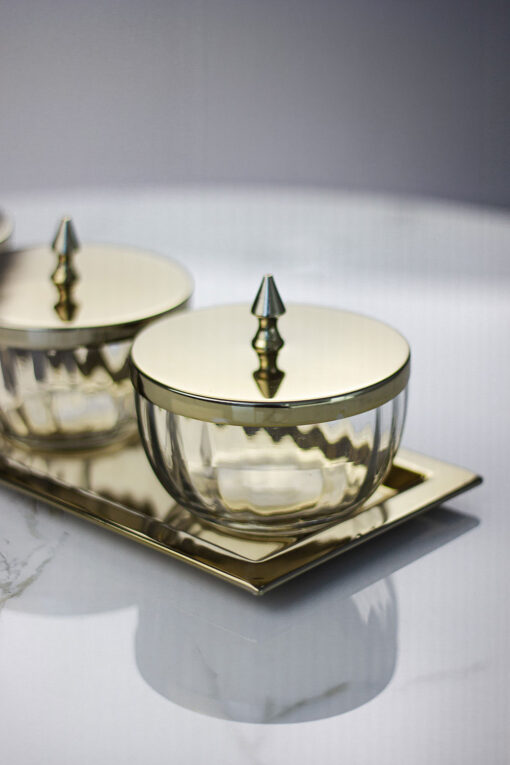 set-of-four-containers-on-a-straight-sided-gold-tray-gold-metal-lids-with-handles-glass-containers-classic-style
