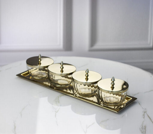 set-of-four-containers-on-a-straight-sided-gold-tray-gold-metal-lids-with-handles-glass-containers-classic-style