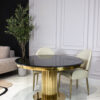 Round dining table on gold designer base, black imitation marble top, glamour, for living room