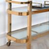 Bar side table on wheels, two-tier, gold metal frame, glass tops, glamour, unique