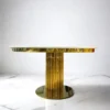 Round dining table on gold designer base, white imitation marble top, glamour