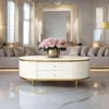 Anne coffee table with fluted white body, gold metal accessories, sintered top