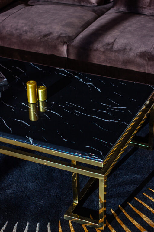 Rectangular coffee table on gold glossy frame, black top imitating marble, modern style, exclusive