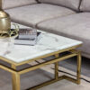 Rectangular coffee table on gold shiny frame, white top imitating marble, modern style, beautiful