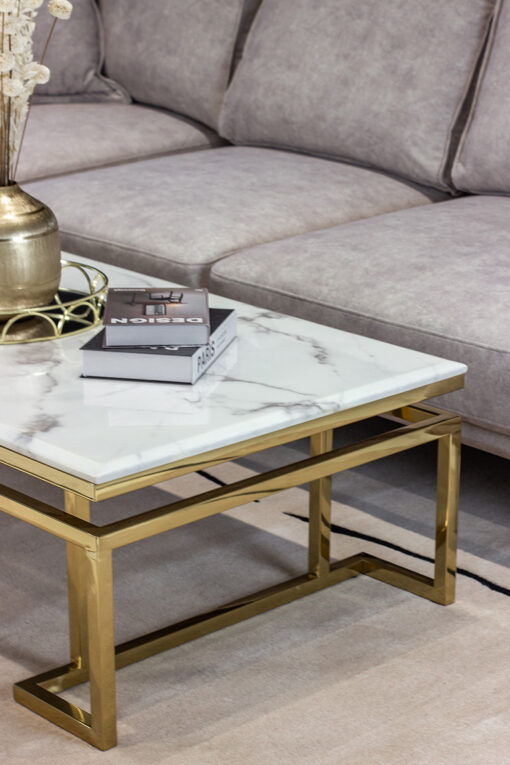 Rectangular coffee table on gold shiny frame, white top imitating marble, modern style, beautiful