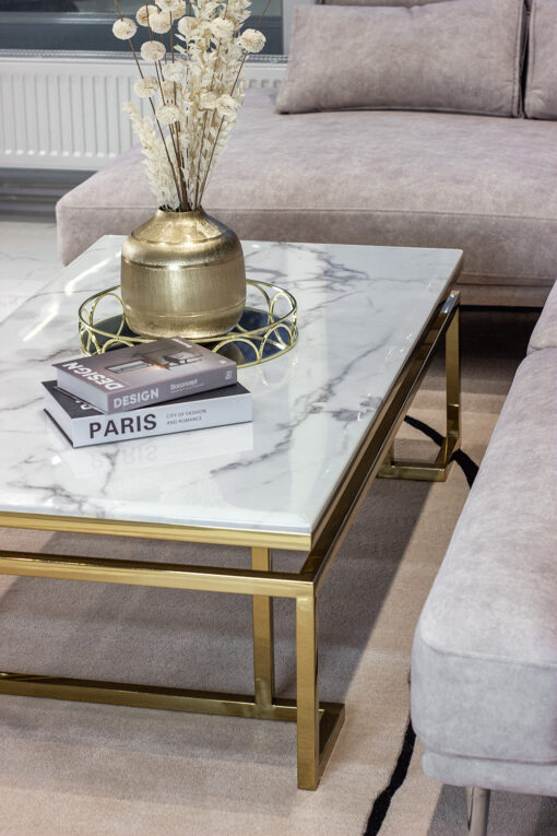 Rectangular coffee table on gold shiny frame, white top imitating marble, modern style, sophisticated