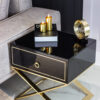 Nightstand with black body on gold metal legs in modern style, for living room