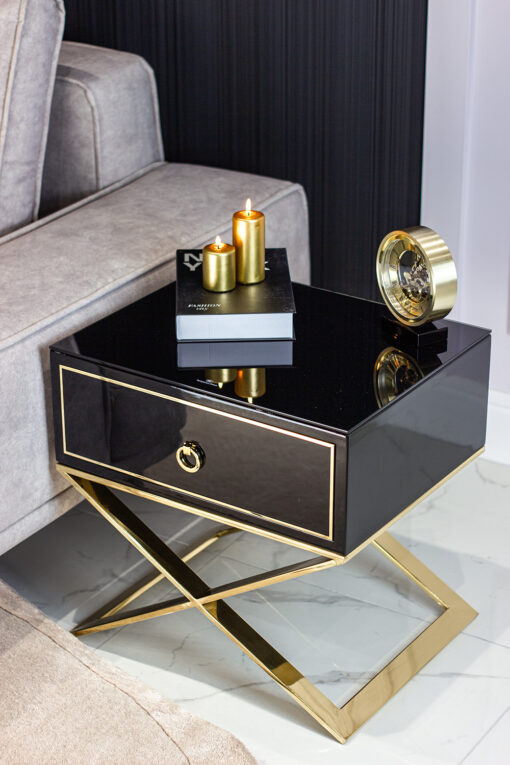 Nightstand with black body on gold metal legs in modern style, for living room